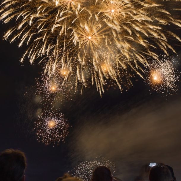 people watching fireworks at nighttime