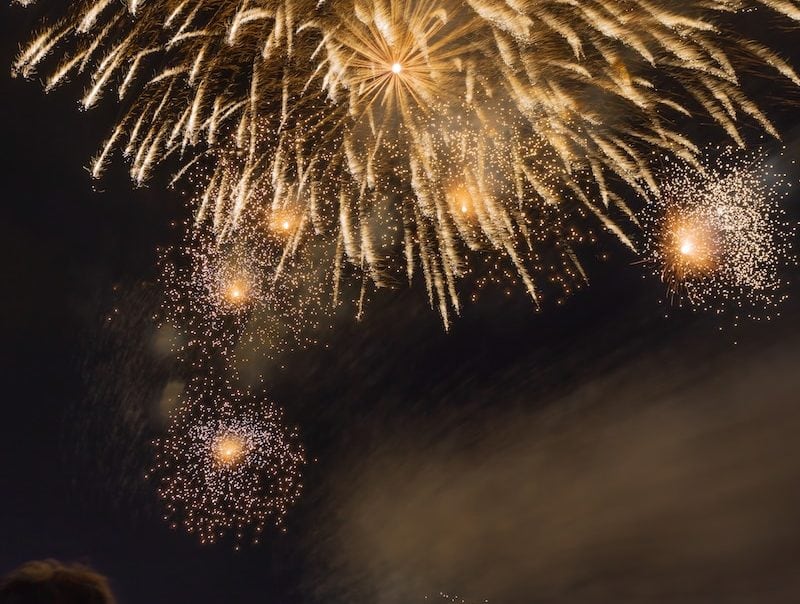 people watching fireworks at nighttime